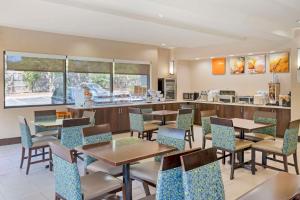 a restaurant with tables and chairs and a counter at Comfort Suites Columbia Northeast - Fort Jackson in Columbia