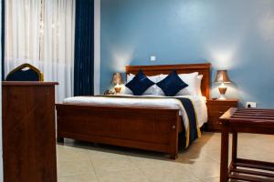 Ένα ή περισσότερα κρεβάτια σε δωμάτιο στο Excelsis Garden Hotels - Kampala