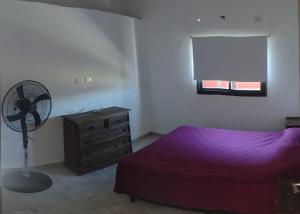 a bedroom with a bed and a fan and a dresser at Complejo Bru-Mar in Los Olivares +25 photos