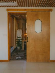 a wooden door leading into a living room at 스테이 마음결,애월 자쿠지펜션 in Jeju