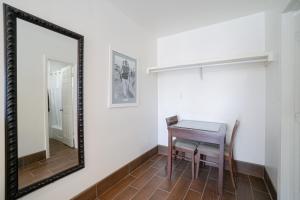 a mirror and a table and chair in a room at SIGNAL HILL MOTEL BEACH MOTEL in Long Beach