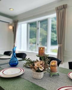 a table with candles and flowers on top of it at HAKONE DOMA in Hakone