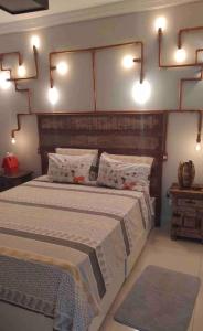 a bedroom with a large bed with a wooden headboard at Flat botique Guarujá in Guarujá