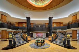 a large lobby with a spiral staircase and a large ball at Sheraton Surabaya Hotel & Towers in Surabaya