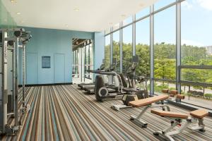 a gym with treadmills and cardio equipment in a building at Aloft Nanhai, Foshan in Nanhai