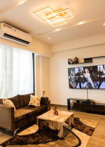 sala de estar con sofá y TV en Chic Retreat - 1-Bedroom Haven en Accra