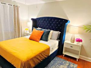a bedroom with a blue and yellow bed with pillows at Towson Center BNB in Towson