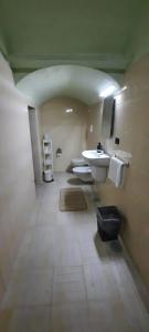 a bathroom with a sink and two toilets in it at I Rifugi di Noah 2-Santa Maria a Vico- in Santa Maria a Vico