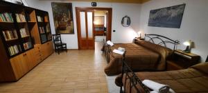 a bedroom with a bed and a couch and a living room at I Rifugi di Noah 2-Santa Maria a Vico- in Santa Maria a Vico