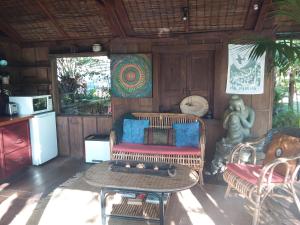 a living room with a couch and a table at Bali Haven in Coromandel Town
