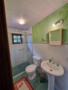ein Badezimmer mit Toilette, Waschbecken und Dusche in der Unterkunft Casa praia de camburi in São Sebastião