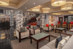 a lobby with couches and tables and a piano at Protea Hotel by Marriott Lagos Kuramo Waters in Lagos