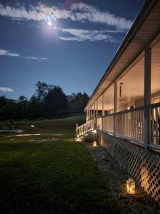 a building with lights on the side of it at night at Moonlight Manor Bed & Breakfast in Floyd