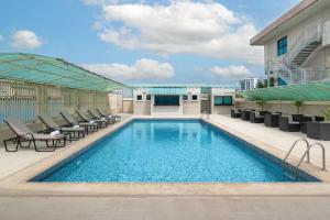 a swimming pool on the roof of a building at Protea Hotel by Marriott Lagos Kuramo Waters in Lagos