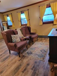 a living room with two chairs and a table at Moonlight Manor Bed & Breakfast in Floyd