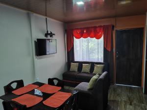 a living room with a table and a couch at The Bees House in Fortuna