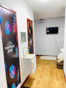 a bathroom with a sink in a room at HOSTAL AMA in Leticia