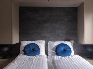two beds with blue pillows on them in a bedroom at Eco Villa near Forest in Netherlands in Oirschot +28 photos
