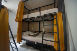 1 Schlafzimmer mit 2 Etagenbetten und gelben Vorhängen in der Unterkunft City Inn Paris in Paris