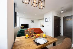 a living room with a table with a bowl of fruit at Chic Luxury Apartment near Old Trafford Stadiums Manchester in Manchester