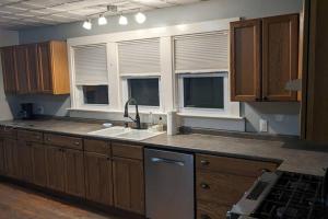 a kitchen with a sink and some windows at Bangor home minutes from airport in Bangor