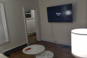 a room with two tables and a tv on the wall at Bangor home minutes from airport in Bangor