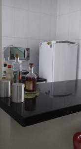 a kitchen counter with bottles of alcohol on it at Sobrado duas quadras da praia in Guaratuba