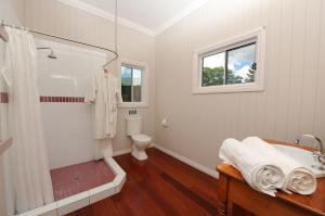 a white bathroom with a shower and a toilet at Samford Lakes in Mount Samson