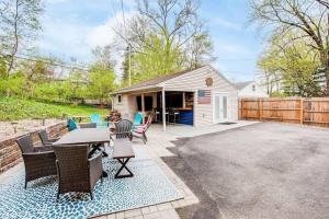 a backyard with a table and chairs and a house at Cozy Home w/ Sonos + Walking to Notre Dame in South Bend