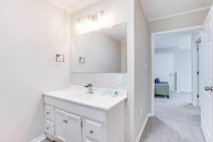 a white bathroom with a sink and a mirror at Cozy Home w/ Sonos + Walking to Notre Dame in South Bend +31 photos