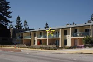 a building with a star on the top of it at Cottesloe Beachfront Ocean View Apartment in Perth