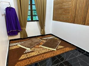 a room with two mats on the floor next to a window at Rania Riverview Guesthouse in Kuala Berang