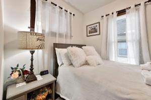 a bedroom with a white bed and a window at AMAZING TRADITIONAL HOME SOUTH MINNEAPOLIS in Minneapolis