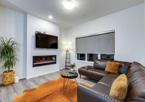 a living room with a couch and a fireplace at Stylish/4Bedroom/FreeParking/IndoorFirePlace in Calgary