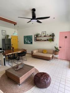 a living room with a couch and a pink door at Casa Ackee in Talamanca
