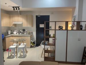 a small kitchen with a table and a counter top at WV Tower 1 Studio in Iloilo City