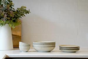 three bowls and a vase on a shelf with a plant at Dunkeld House - Beautiful country accomodation in Dunkeld