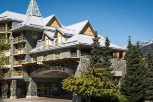 a large building with a tower on top of it at 900 SQFT 2 Bed 2 Bath Renovated Suite at Cascade Lodge in Whistler Village Sleeps 6 in Whistler