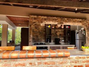 a kitchen with a counter and a stove top oven at Villa Lela, best way to chill & relax ! in Lemos