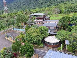 an aerial view of a resort with a building and trees at Sun Lu Holiday Homestay in Jiamin