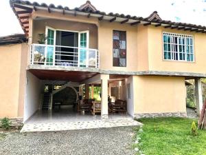 a house with a balcony and a patio at Villa Lela, best way to chill & relax ! in Lemos