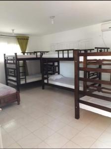 a room with several bunk beds in a room at Ukiyo Cabin in Santa Marta
