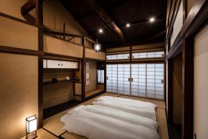a bedroom with a large white bed in a room at Rinn Premium Nijo Castle North in Kyoto