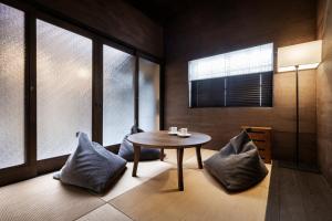 a dining room with a table and some windows at Rinn Premium Nijo Castle North in Kyoto
