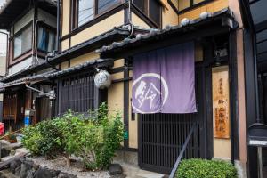 a building with a purple sign on the side of it at Rinn Premium Nijo Castle North in Kyoto +49 photos