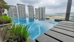 a swimming pool on the roof of a building with tall buildings at A1. The Ins @ Aurpra Place beside Pavillion Bukit Jalil in Kuala Lumpur