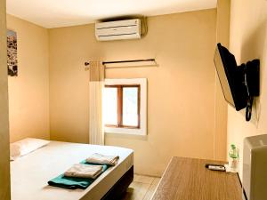 TV in/ali zabaviščno središče v nastanitvi Hotel Syariah Larismanis