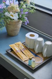 a tray with toilet paper and toiletries on a counter at The Trust Ville in Bangkok