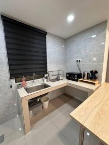 a kitchen with a sink and a black blind at Minimalist City View Home with 3BR at Meru Ipoh in Bandar Meru Raya