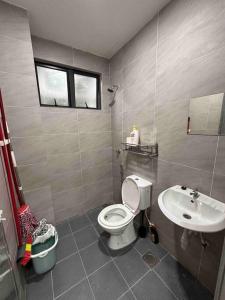 a bathroom with a toilet and a sink at Minimalist City View Home with 3BR at Meru Ipoh in Bandar Meru Raya